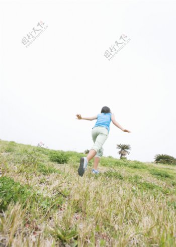 草地上奔跑的女生图片