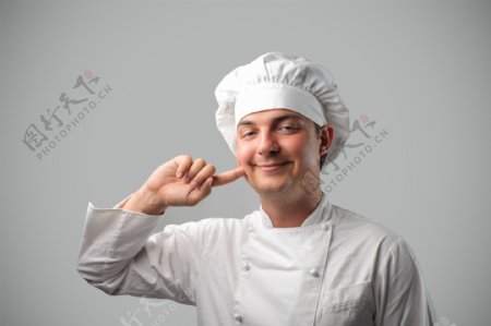 指头触脸的厨师图片